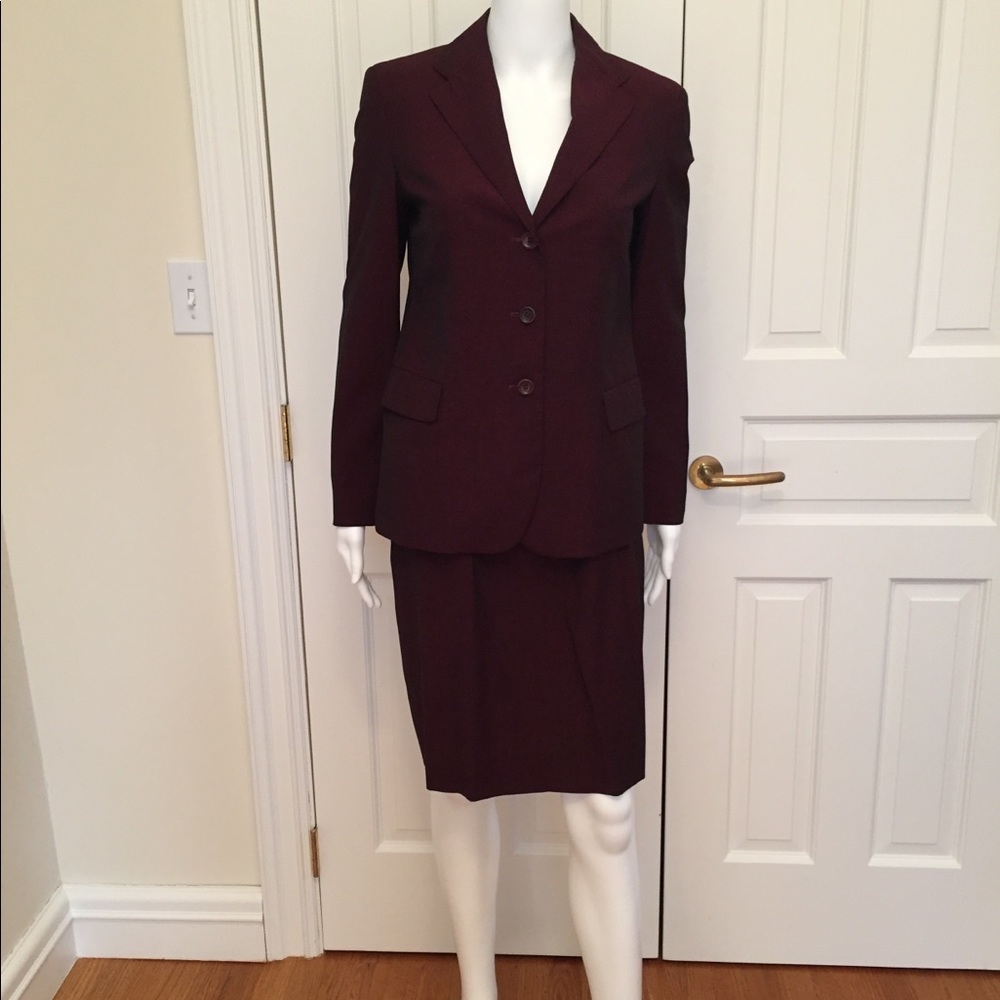 Gabrielle Strennese Bordeaux colored suit.